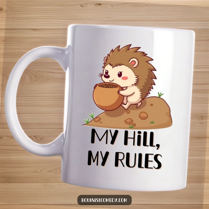 Funny hedgehog mug featuring a determined hedgehog character pushing a large, round seedpot uphill with all its might.